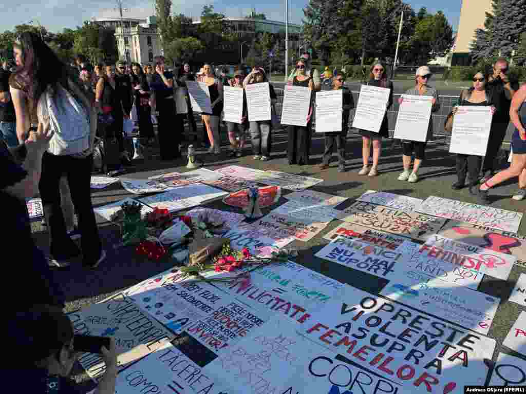 Protesters display banners decrying violence against women and lay flowers in memory of Teodora Marcu. The 23-year-old was shot dead, allegedly by her ex-boyfriend Robert Lupu, while walking with her 3-year-old daughter on May 31. Marcu was 26 weeks pregnant at the time.
