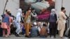 AFGHANISTAN -- Afghans queue up as they wait for the banks to open and operate at a commercial area in Kabul, August 31, 2021 - AFP