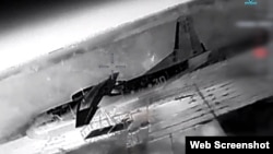 A screenshot from a video from Ukraine's Defense Ministry purports to show the downing of an An-26 aircraft at an airfield in Crimea. 