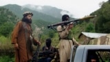Members of the Pakistani Taliban patrol Shawal in the Pakistani tribal region of South Waziristan in August 2011. 